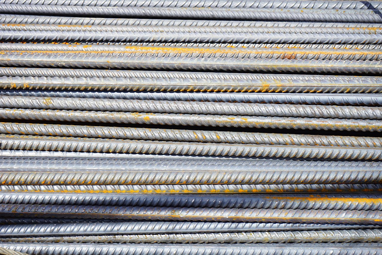 about-03 Close-up of stacked rusty steel reinforcing bars used in construction.
