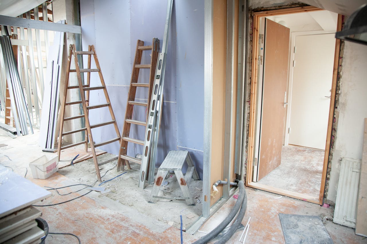 services-02 Construction site featuring ladders and tools in a home renovation setting.